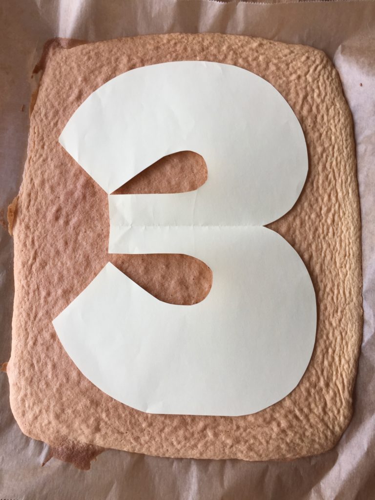 Die Zahl für den Number-Cake wird aus dem Biskuitboden geschnitten.