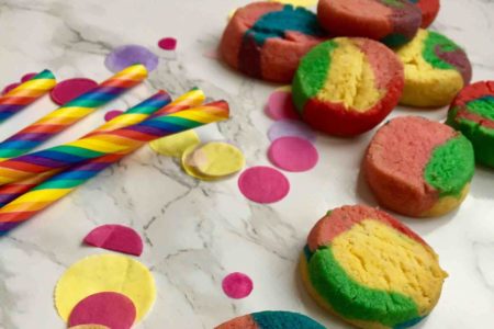 Aus einer Keksrolle entstehen kunterbunte Regenbogenkekse - einfaches Mottobacken für Kinder